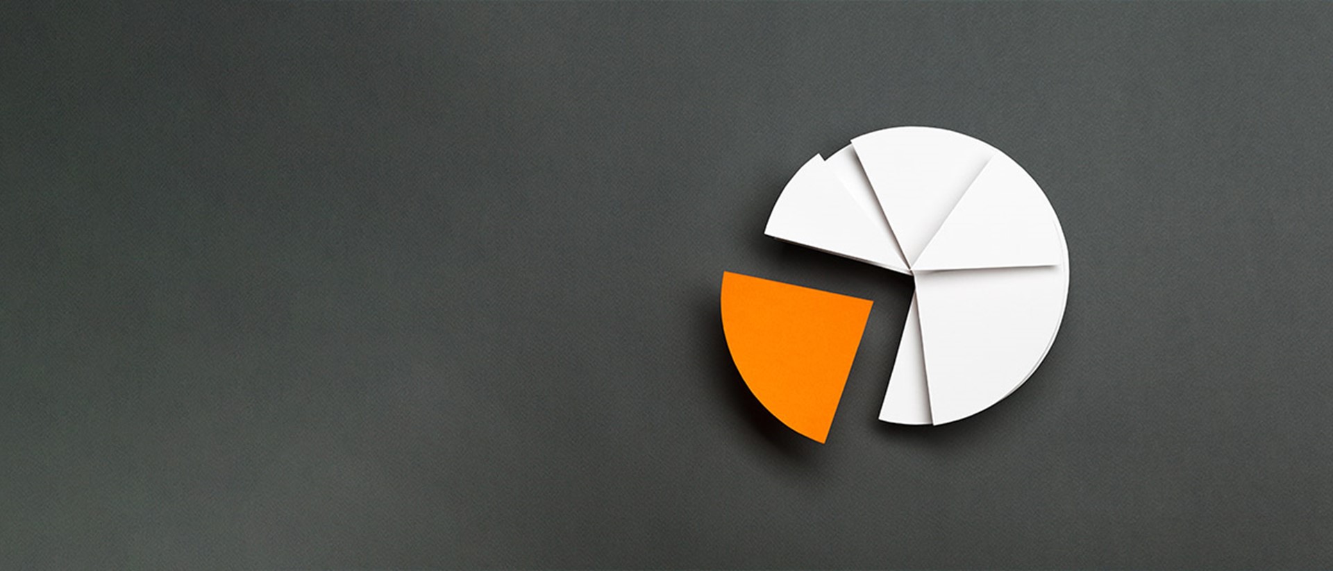 Image of a white pie chart with an orange slice taken out of it on a black background