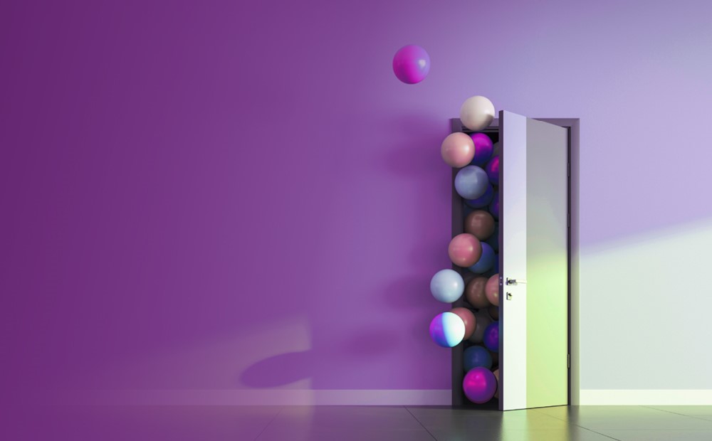 Image of balls flowing through a door with a purple background