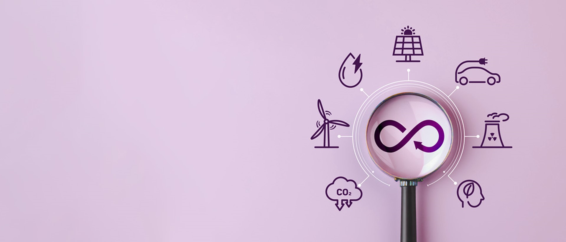 A magnifying glass looking at an infinite symbol with several sustainability icons surrounding it against a pink background.