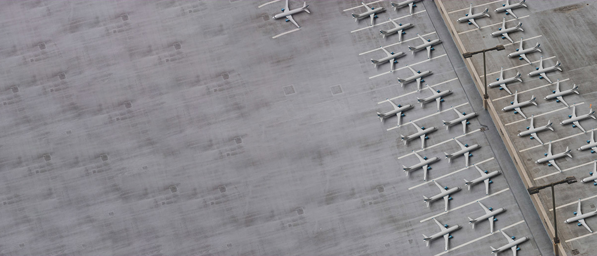 Image of airplanes parked with an orange arrow on the tarmac