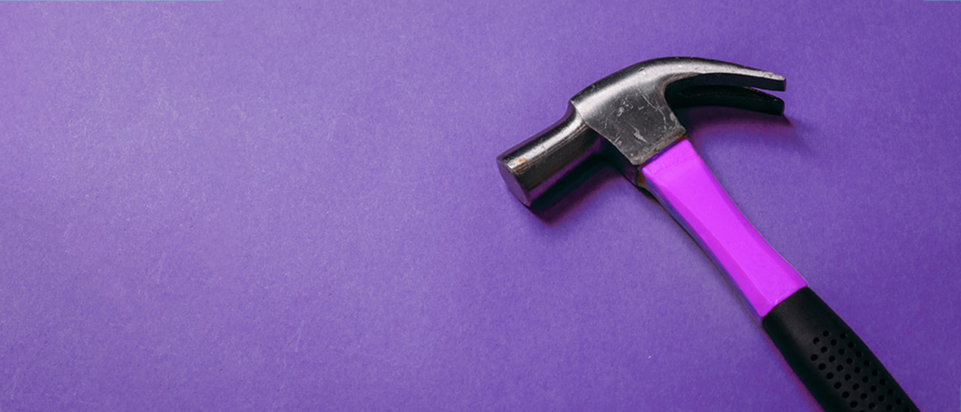 A purple hammer against a purple background