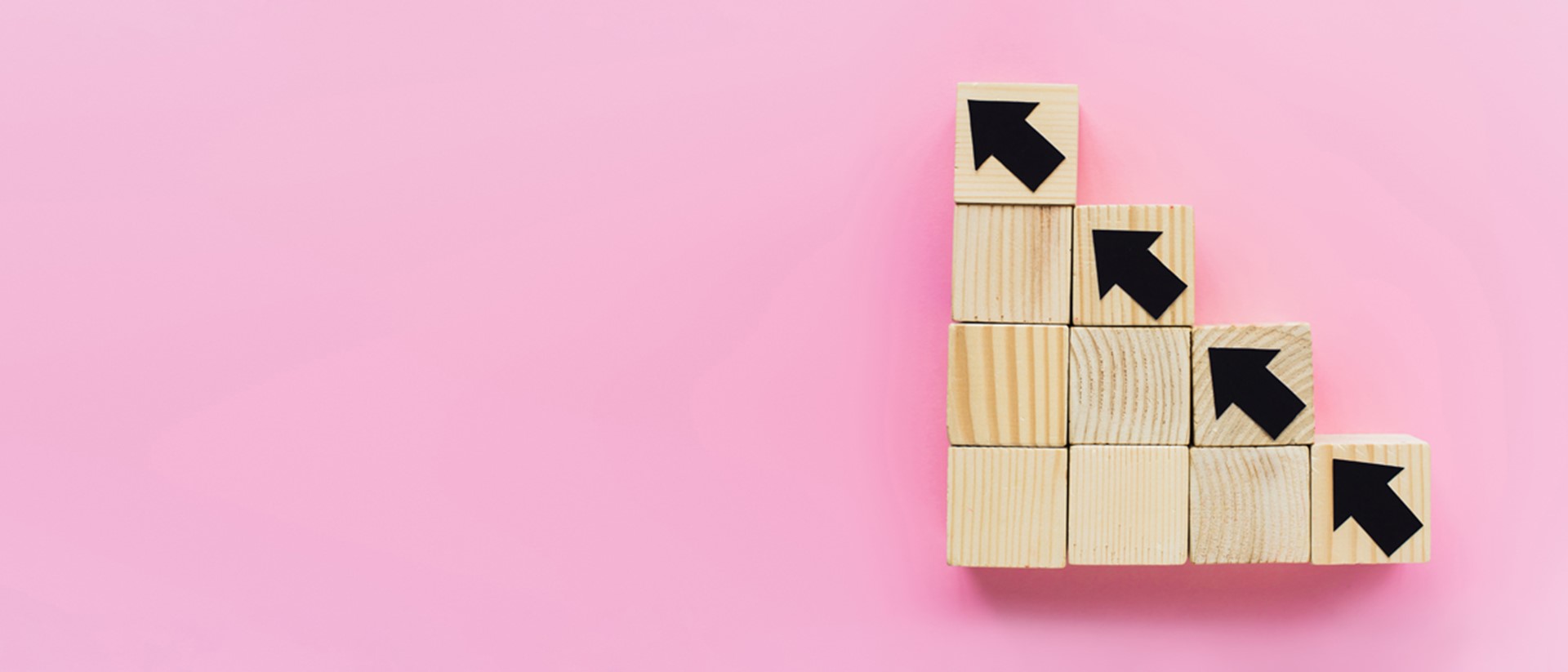 Image of wooden blocks going diagonally against a pink background
