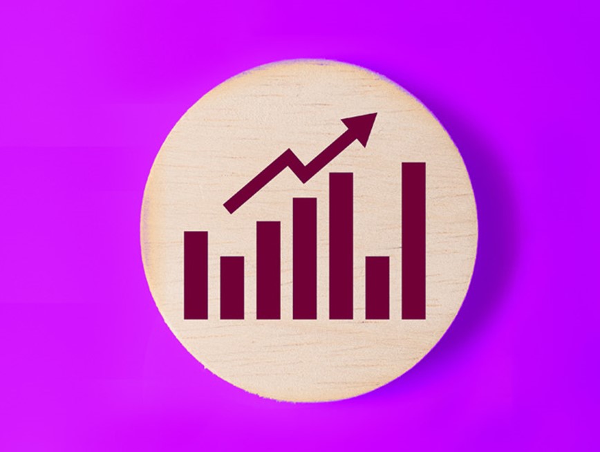 A circular wooden disk with a bar chart printed on against a purple background