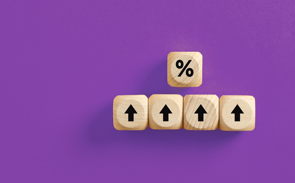 Image of wooden blocks with arrows pointing upwards against a purple background
