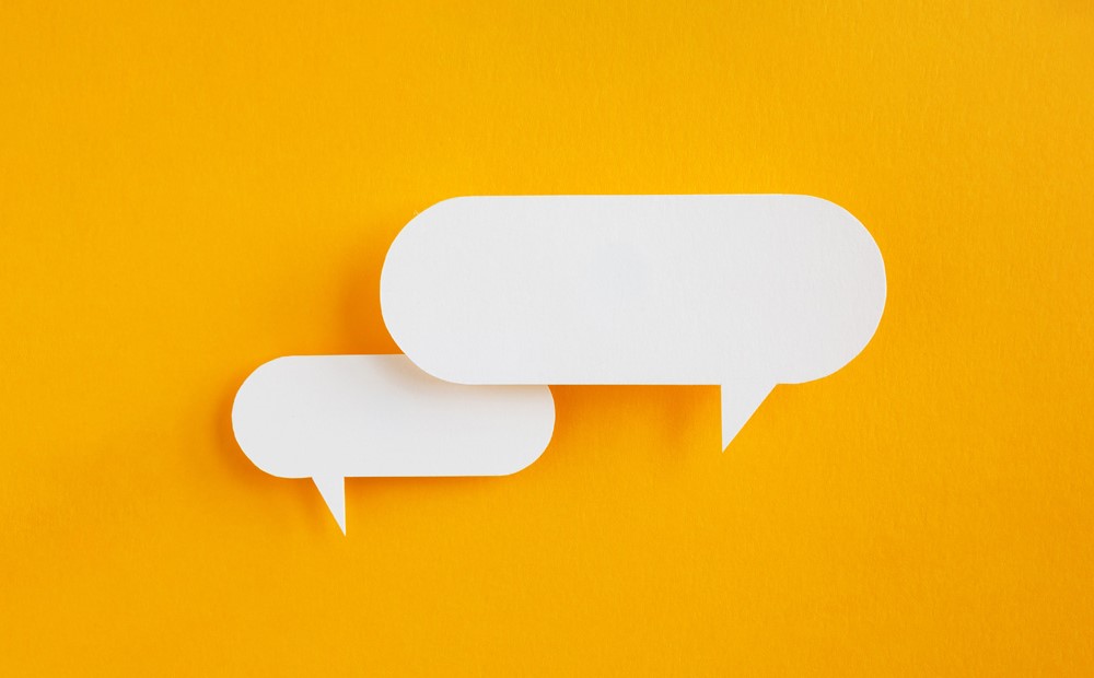 Two white speech bubbles against an orange background
