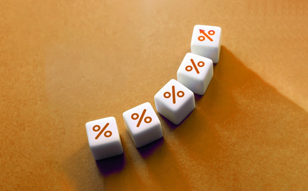 Five dice with a percentage symbol on each against an orange background