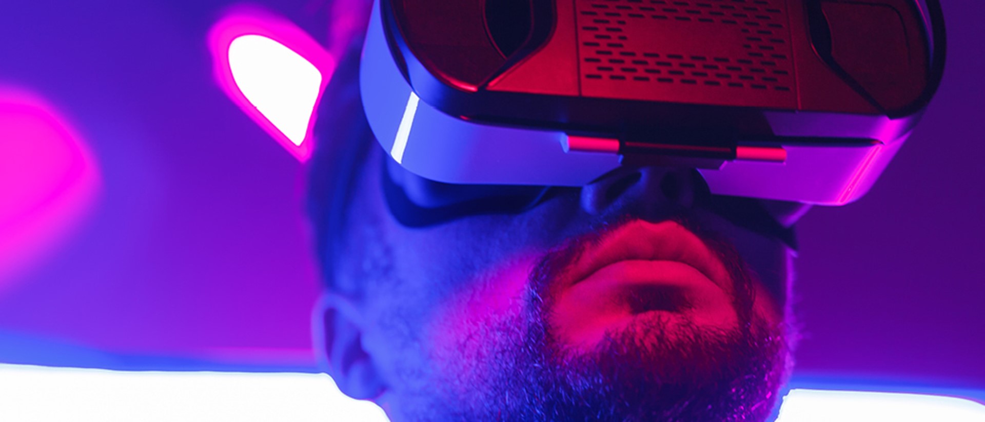 Image of a man with a virtual reality headset with a purple background