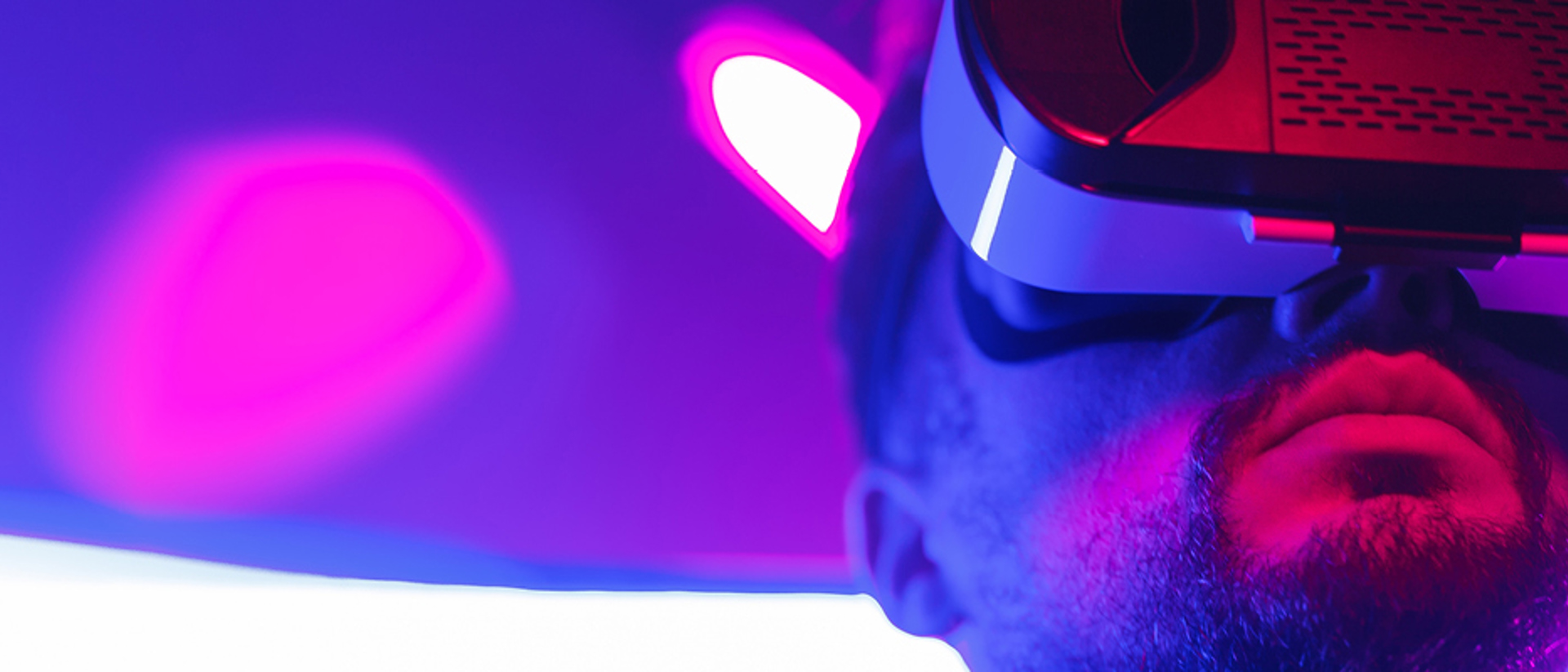 Image of a man with a virtual reality headset with a purple background