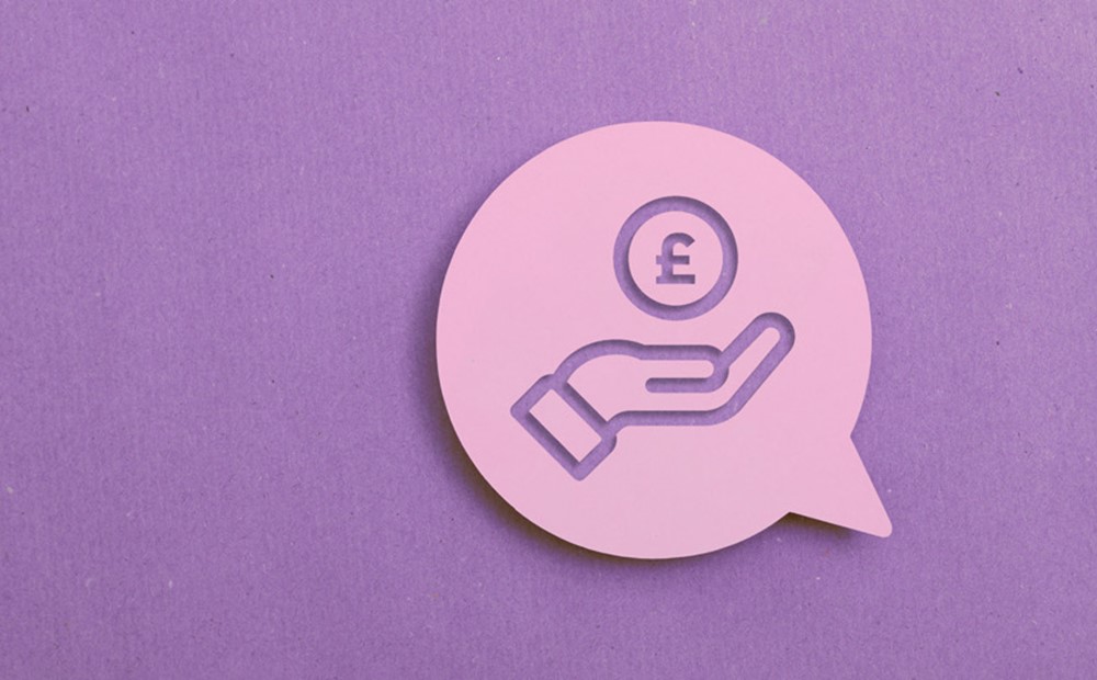 Image of a hand and a coin within a light purple speech bubble, against a purple background