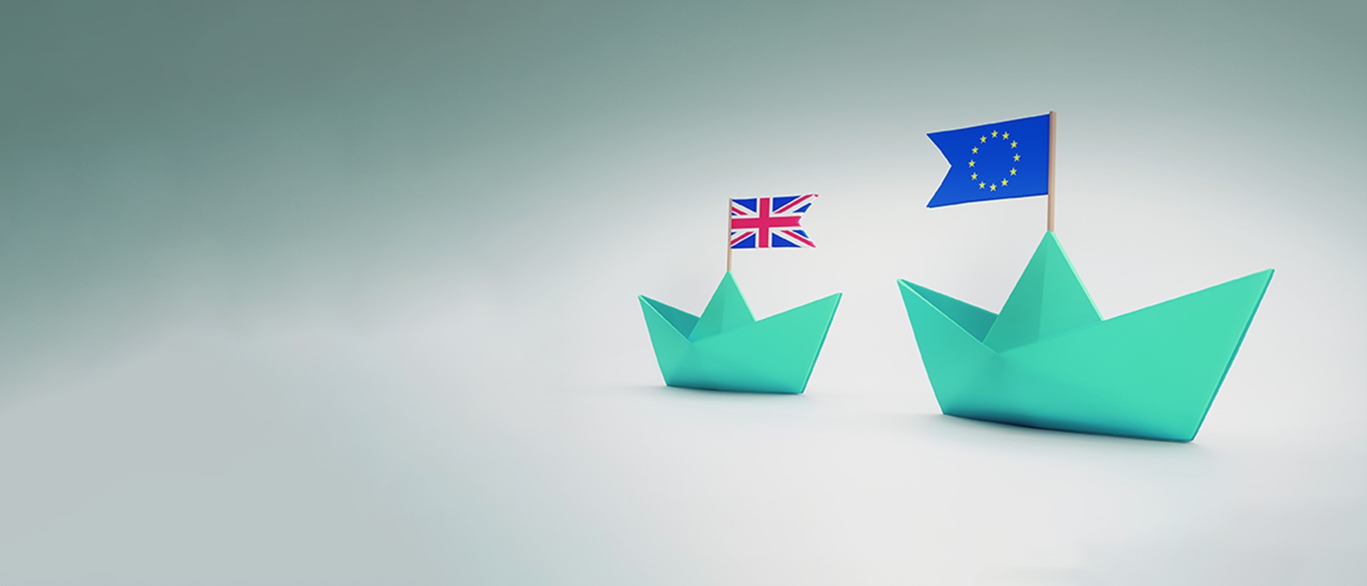 Image of blue paper boats with a union jack flag on one and the European flag in the other