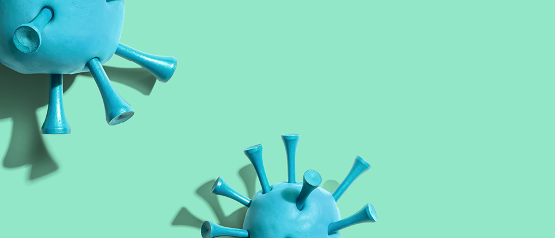 Image of blue viruses on a teal background