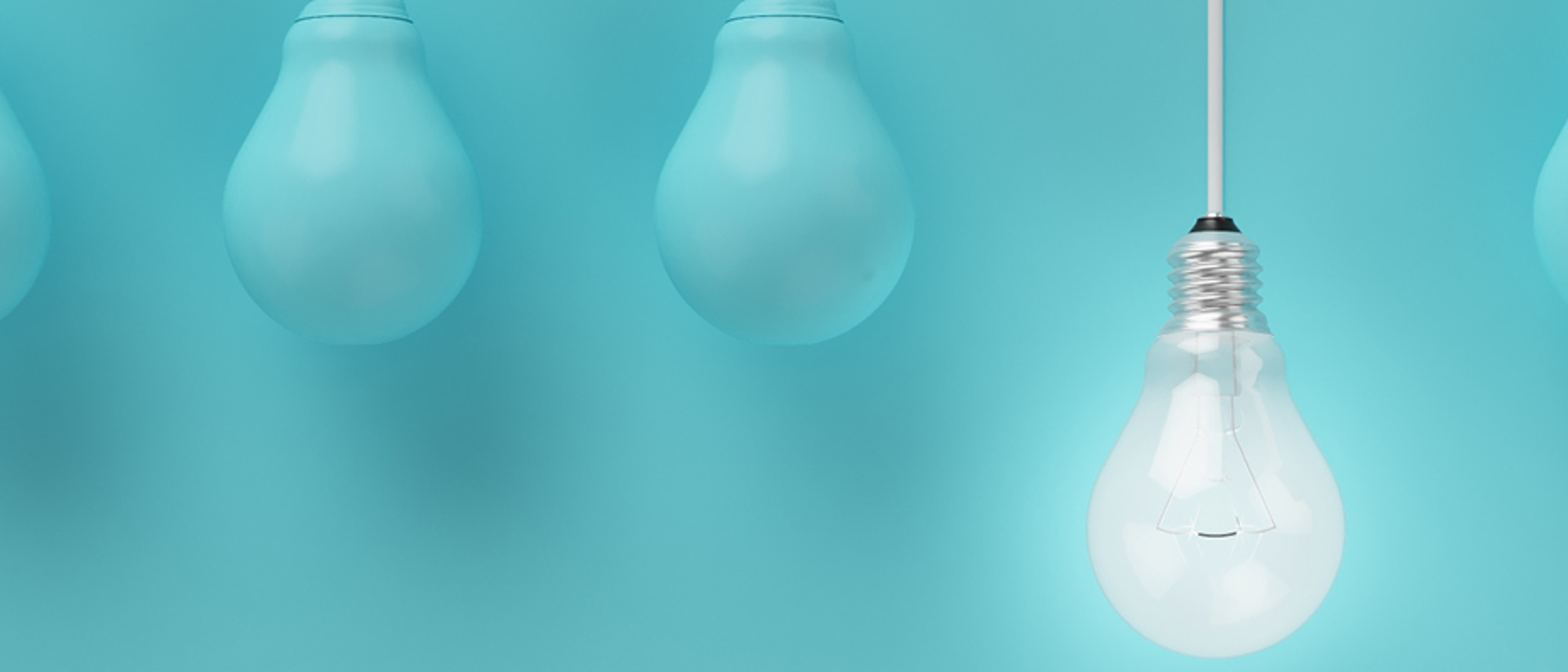 Image of a lightbulb hanging down with blue lightbulbs either side on a teal background