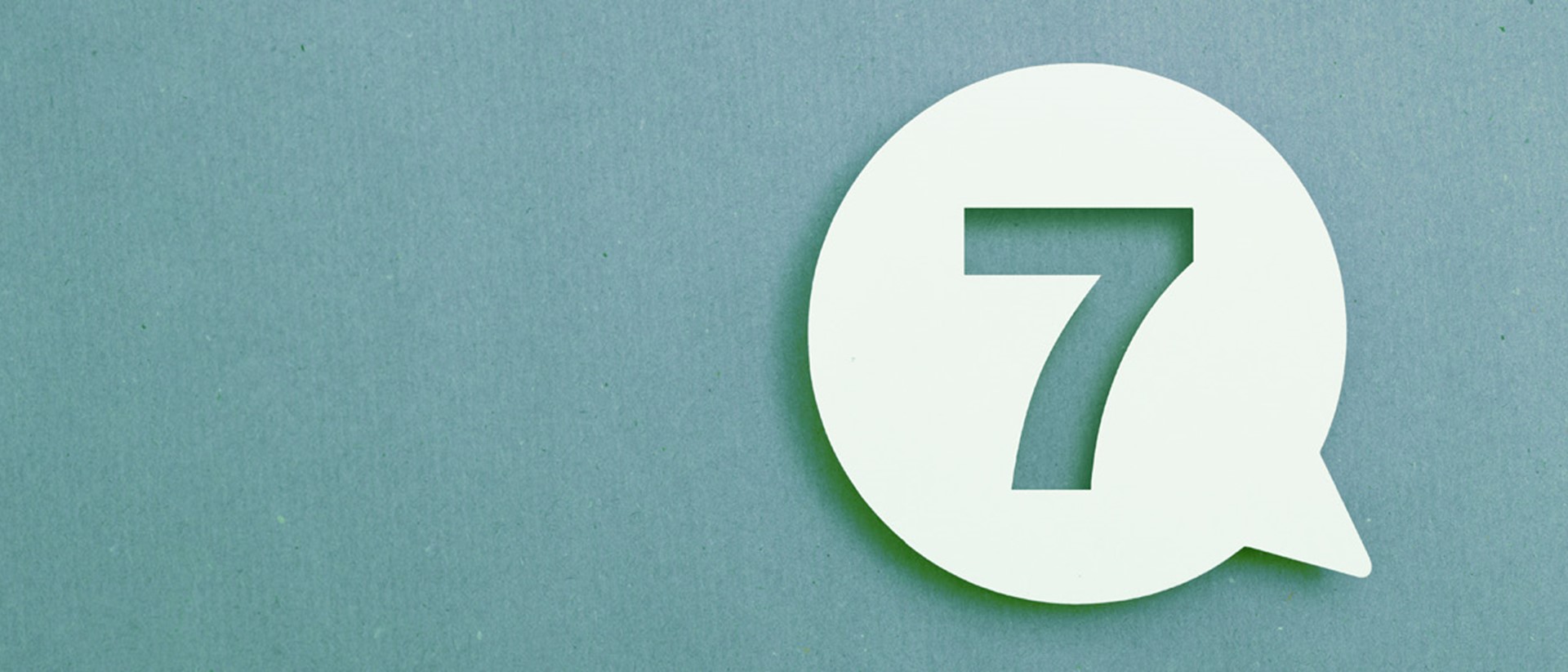 The number seven in a speech bubble against a teal background