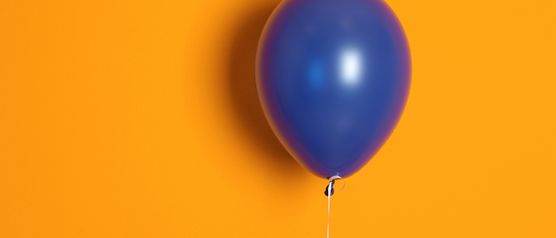 Image of a blue balloon on an orange background