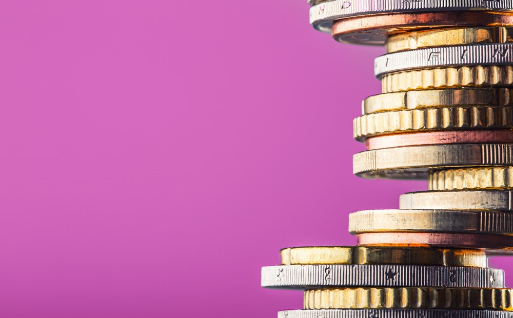 A stack of coins against a purple background