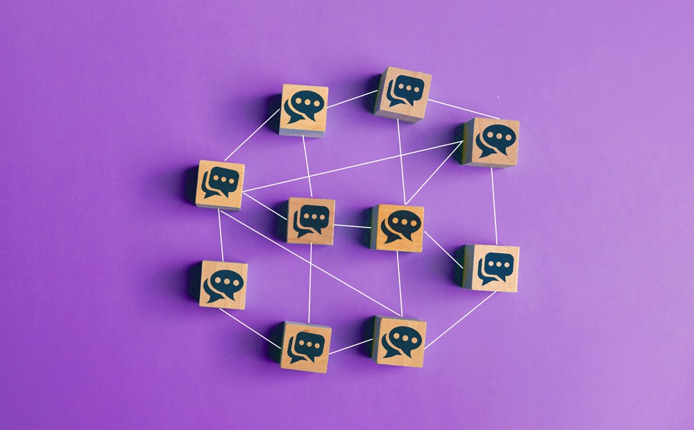A web of multiple wooden blocks, each with a symbol of a brain against a purple background.