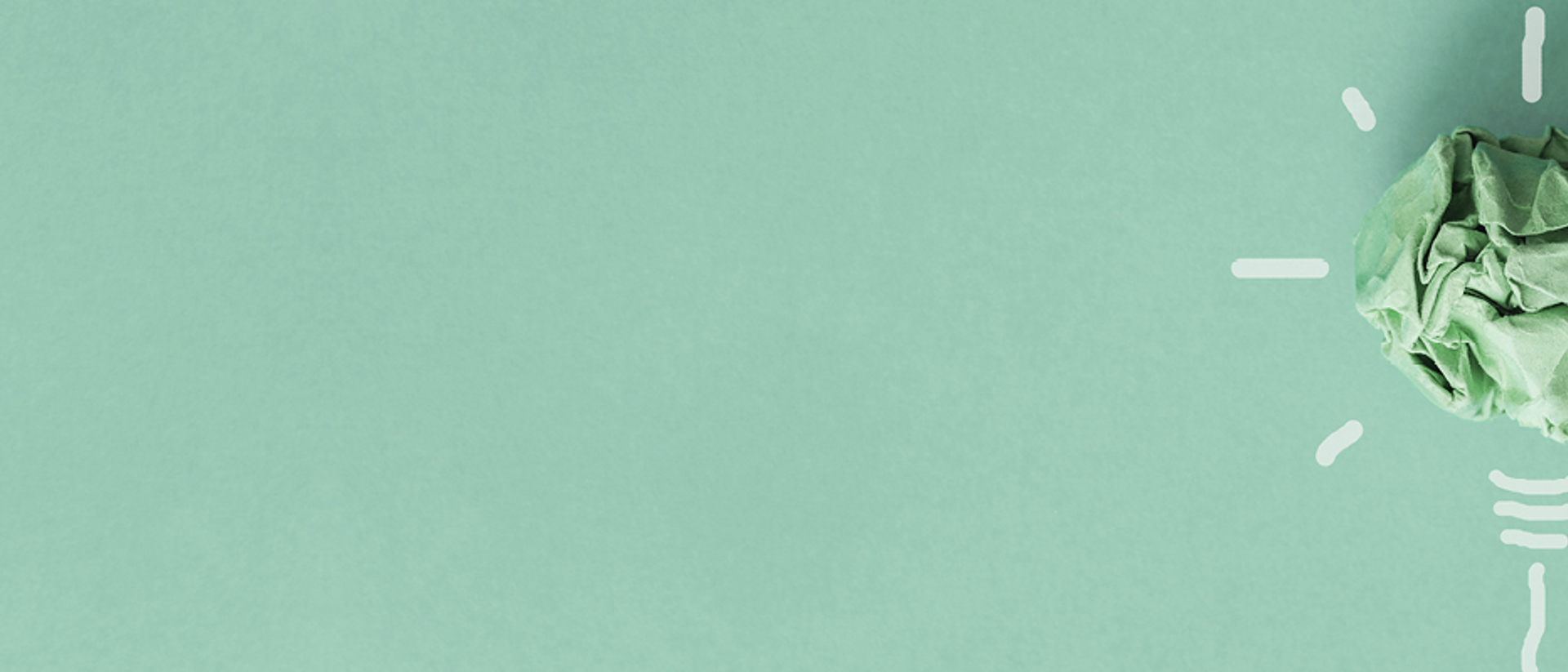 Image of a green ball of paper in a shape of lightbulb on a teal background