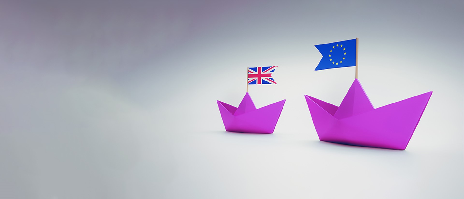 Image of purple paper boats with a union jack flag on one and the European flag in the other