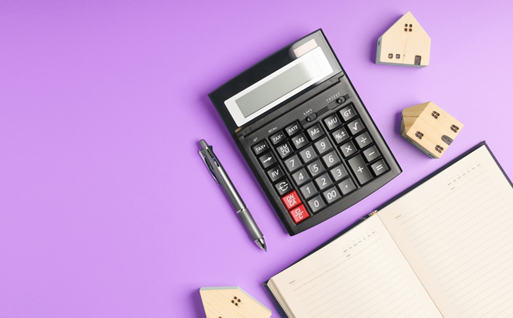 Image of a calculator and planner on a purple background