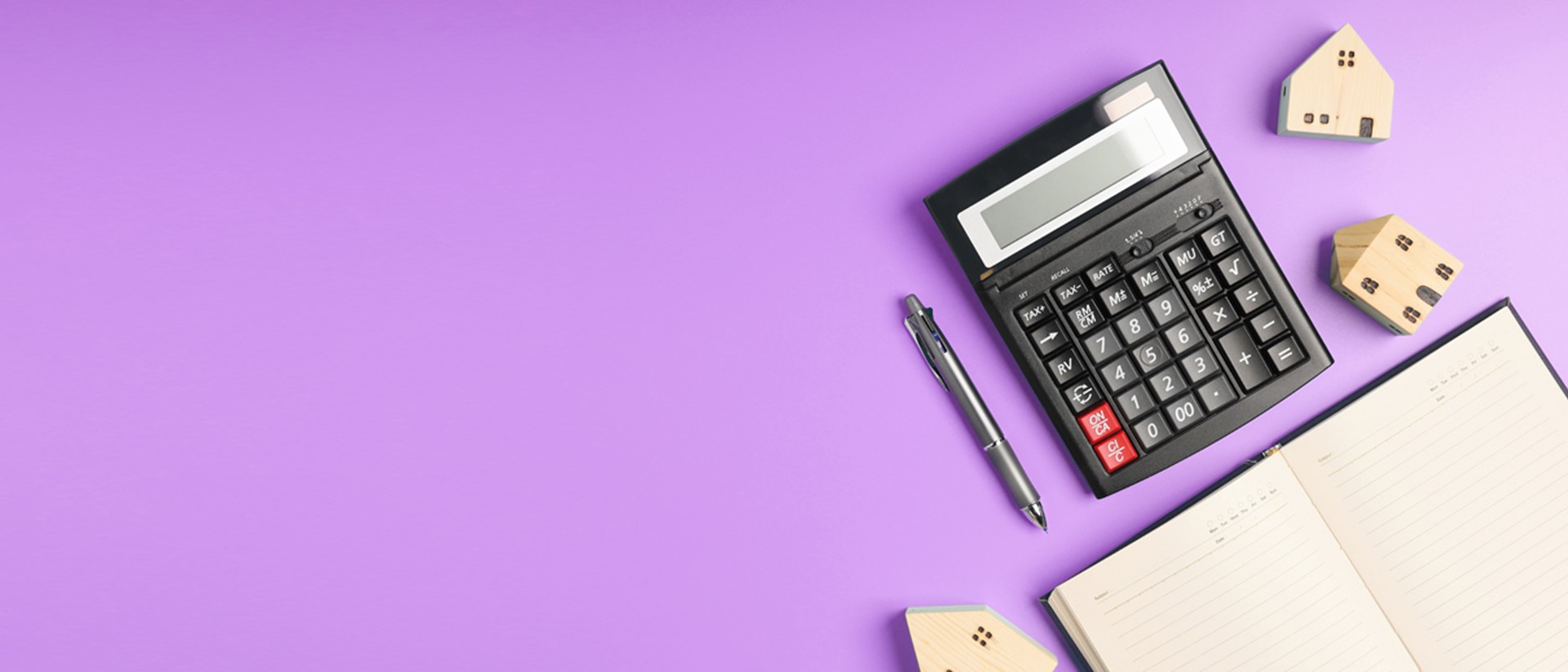 Image of a calculator and planner on a purple background