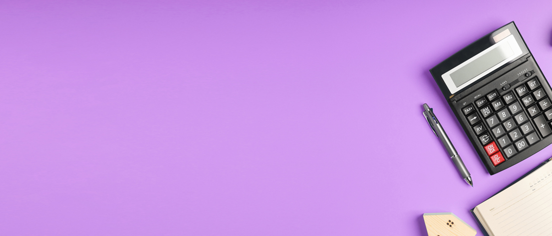 Image of a calculator and planner on a purple background