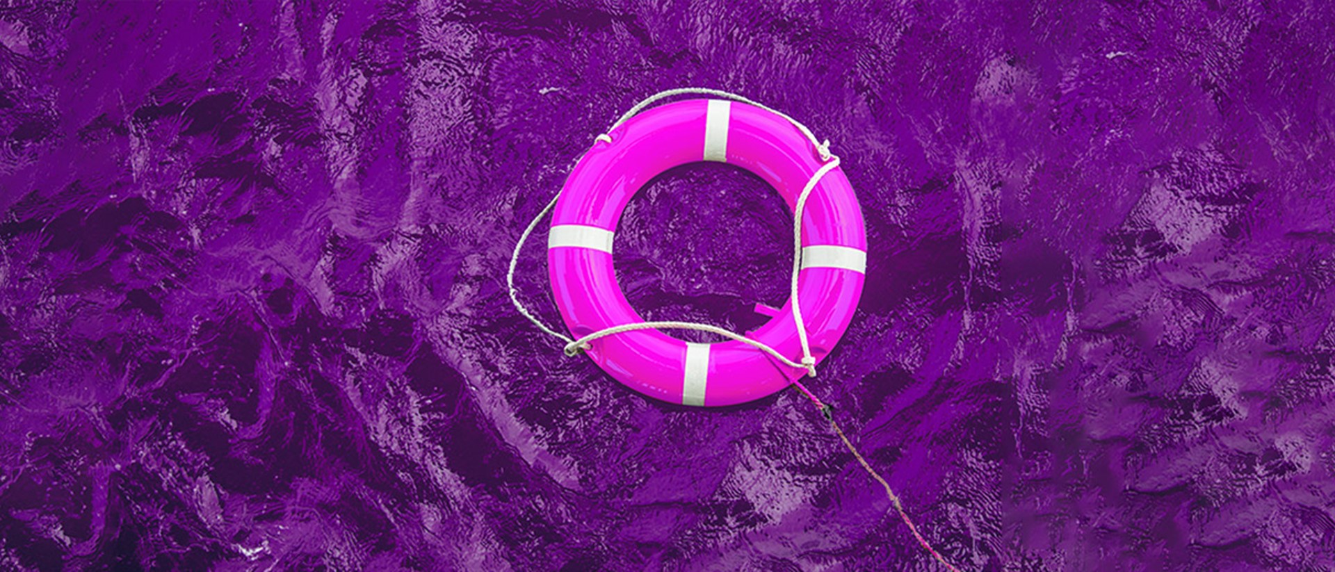 Image of a purple life raft on purple water