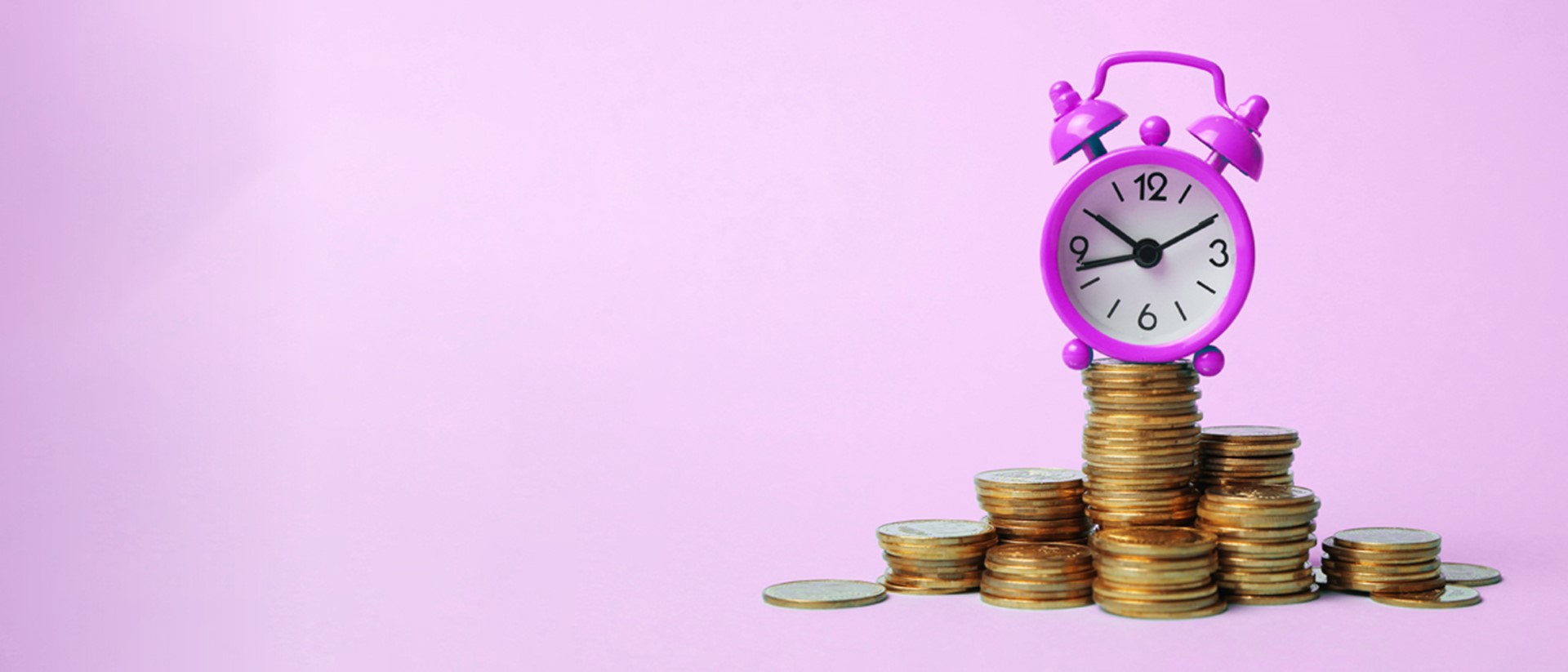 Image of a purple alarm clock sat on a pile of coins on a purple background