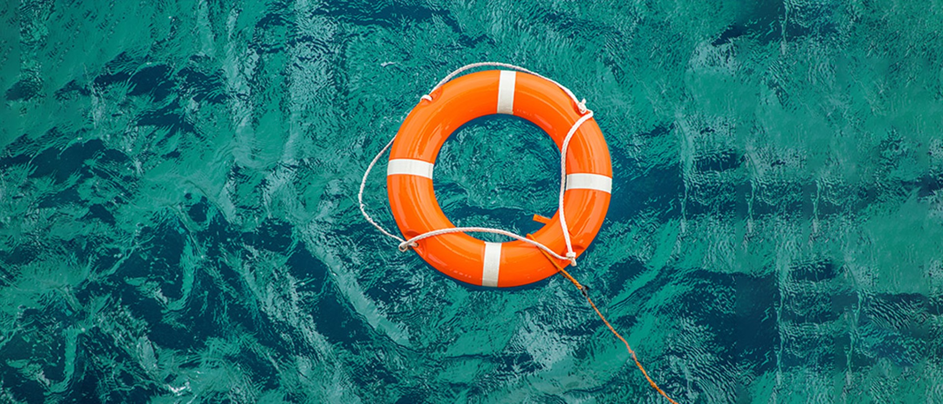 Image of an orange life raft on water