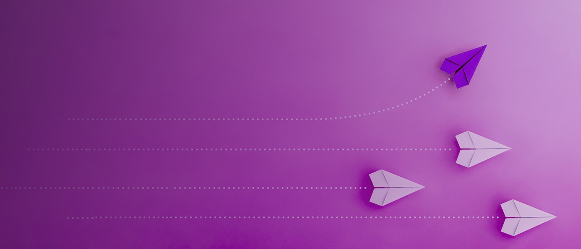 Image of paper airplanes flying to the right on a purple background