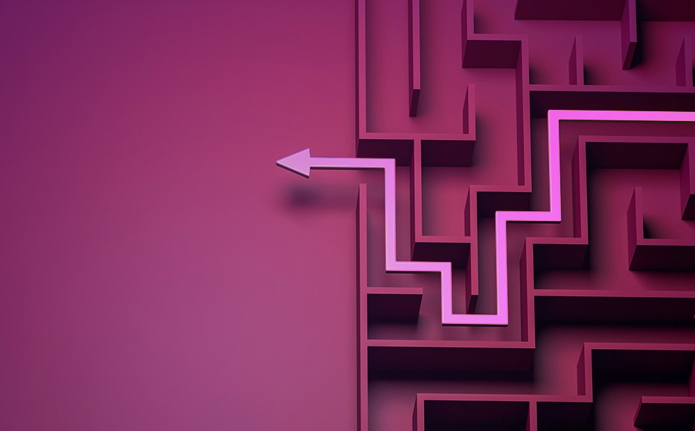 Image of a pink arrow going through a purple maze