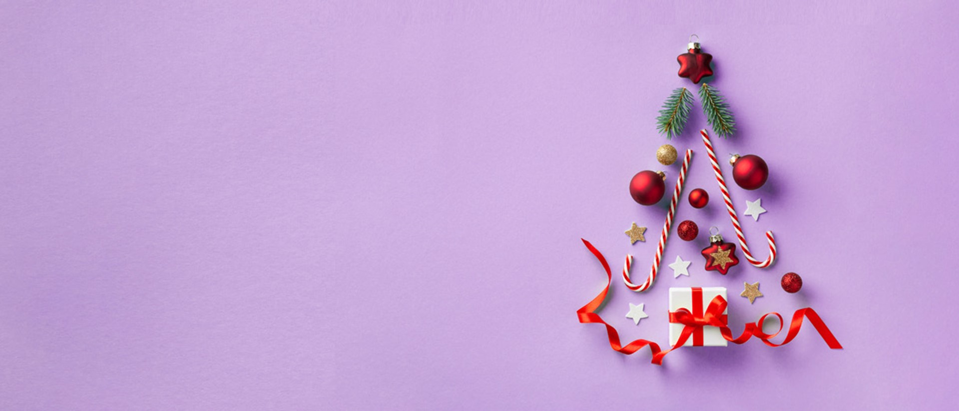 Image of Christmas items forming a shape of a Christmas tree against a purple background