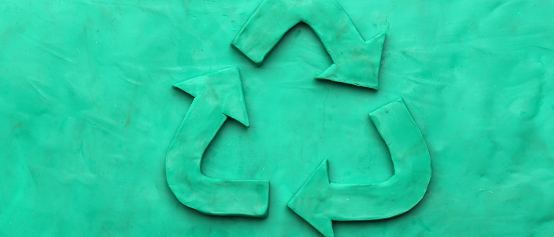 Image of a teal recycling logo on a teal background