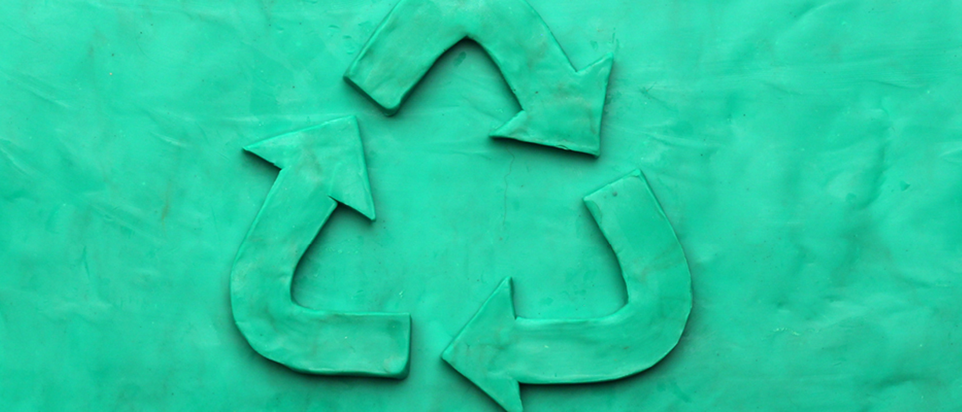 Image of a teal recycling logo on a teal background