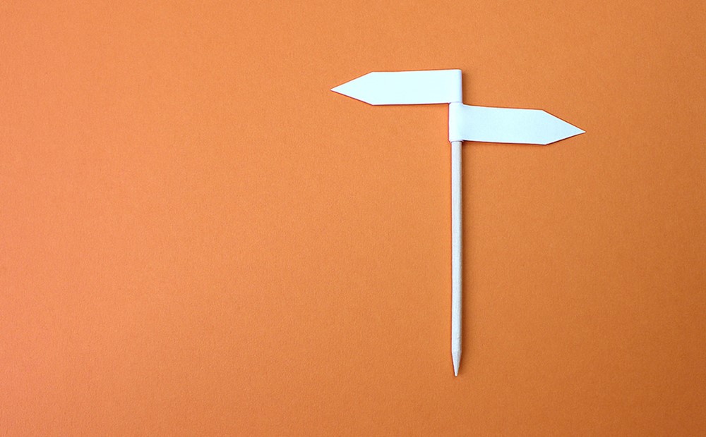 Image of a small road fork on an orange background