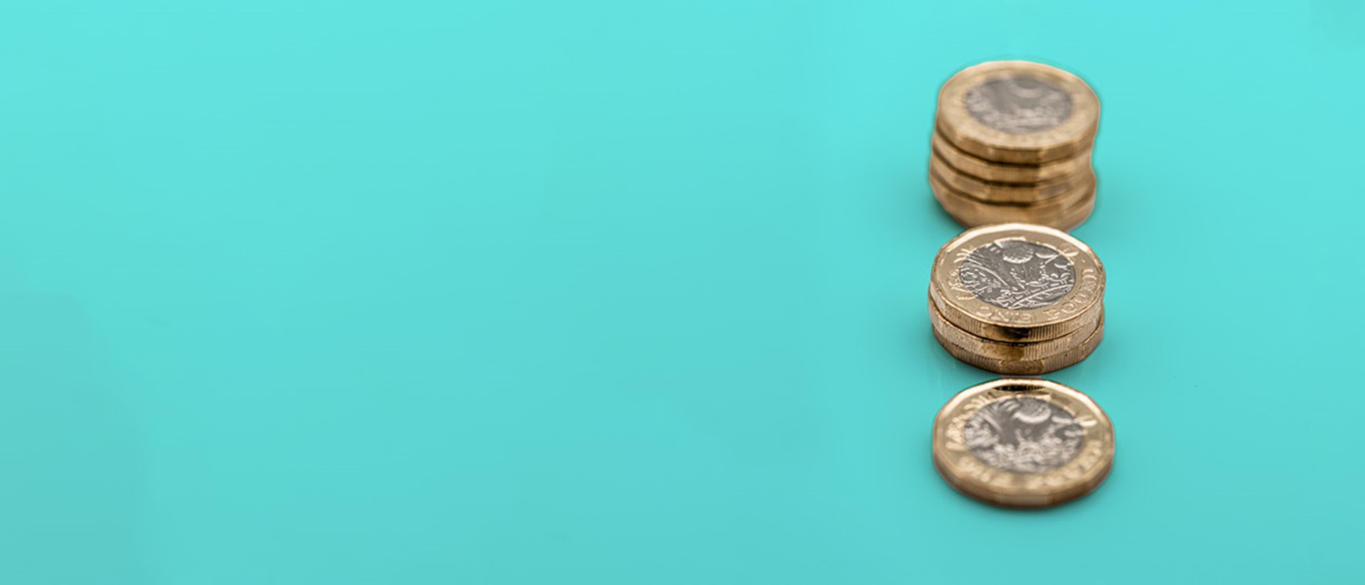 Image showing stacks of pound coins against a teal background