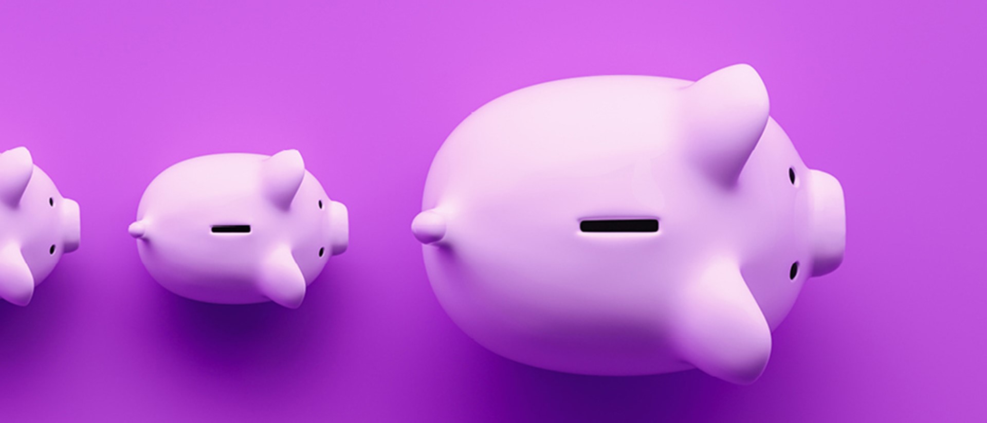 Image of piggy banks in a line on a purple background