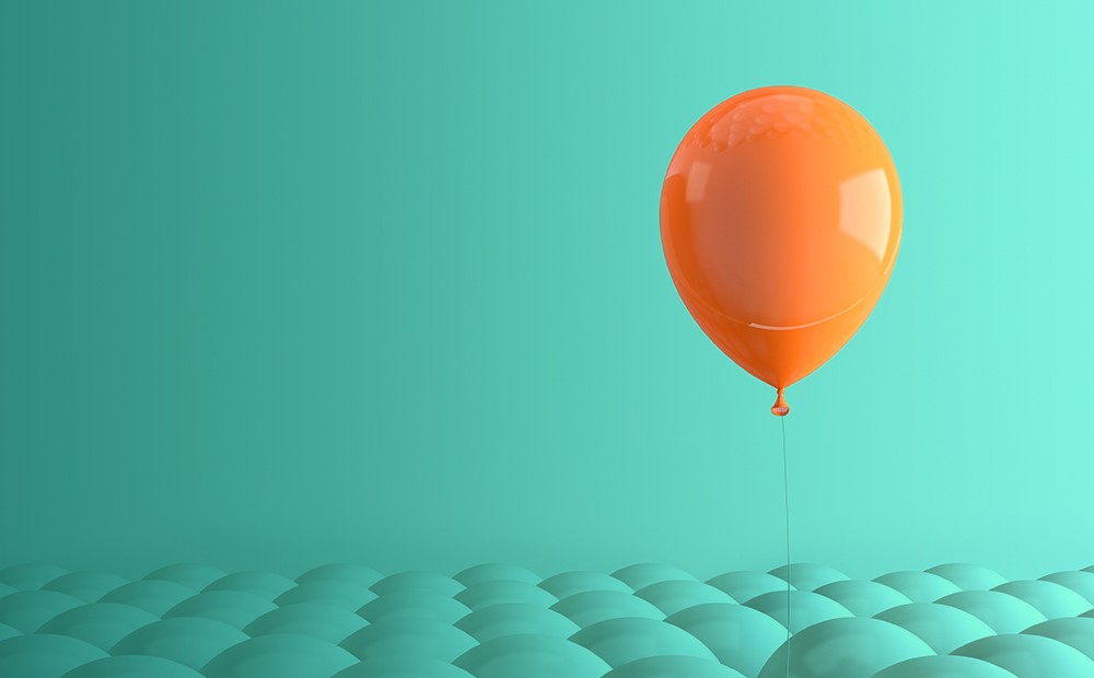 Image of an orange balloon on a teal background
